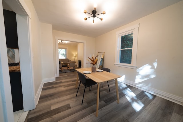 dining space featuring a chandelier and dark wood-type flooring