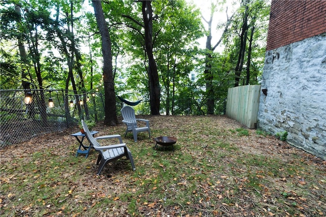 view of yard with a fire pit