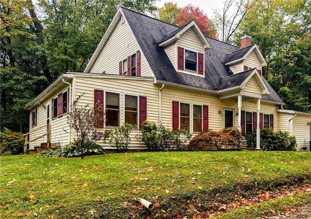 new england style home featuring a front yard