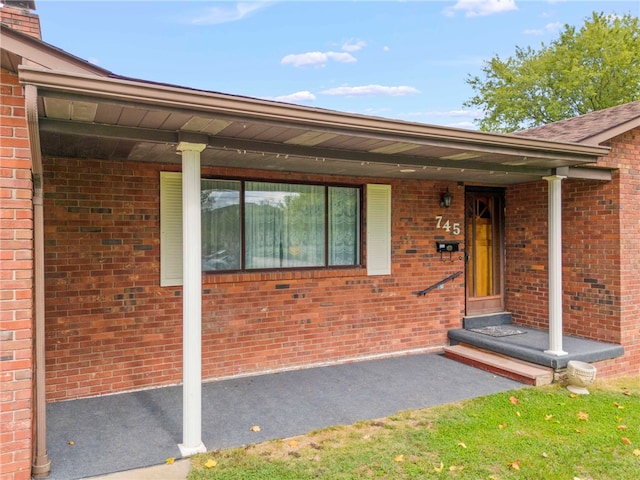 view of exterior entry featuring a porch