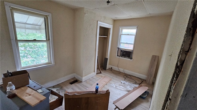 bedroom featuring a paneled ceiling and hardwood / wood-style floors