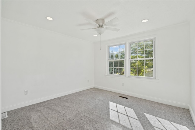 carpeted empty room featuring ornamental molding and ceiling fan