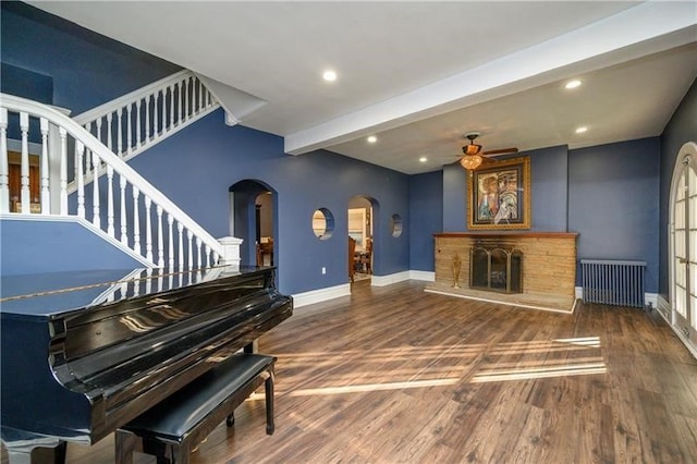 miscellaneous room featuring radiator, dark hardwood / wood-style flooring, and beamed ceiling