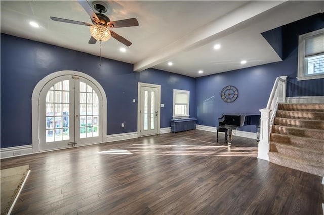 entryway featuring beamed ceiling, dark hardwood / wood-style floors, radiator, ceiling fan, and french doors