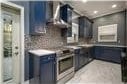 kitchen with decorative backsplash and blue cabinets