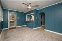 unfurnished bedroom featuring dark carpet, crown molding, and ceiling fan