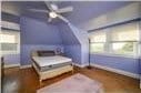 bedroom featuring wood-type flooring and multiple windows