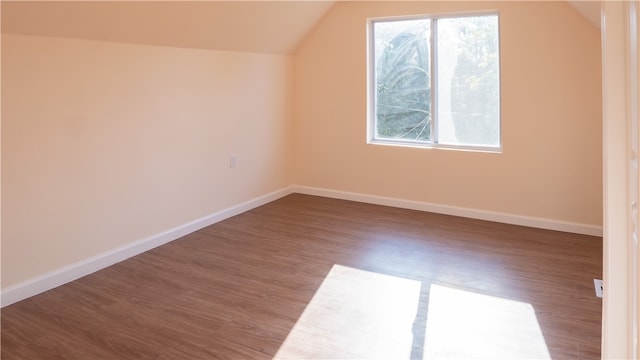 bonus room with vaulted ceiling and dark hardwood / wood-style flooring