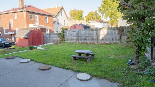 view of yard with a patio and a storage unit