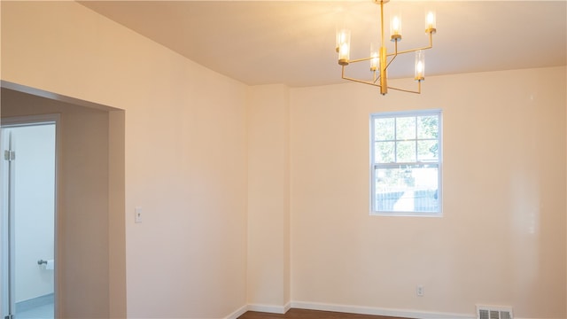 empty room with an inviting chandelier