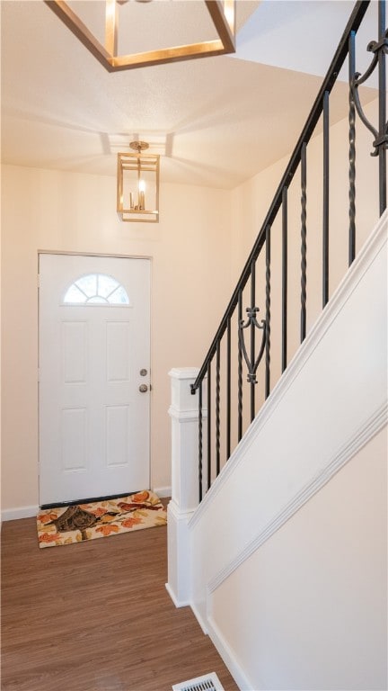 foyer with wood-type flooring