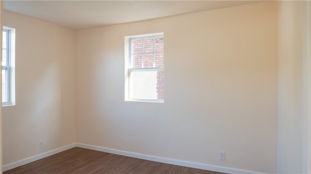 spare room with dark hardwood / wood-style flooring