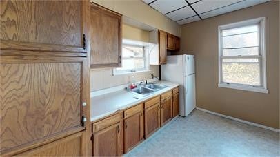 kitchen featuring white refrigerator and sink