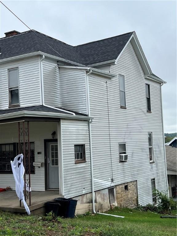 back of house featuring a porch