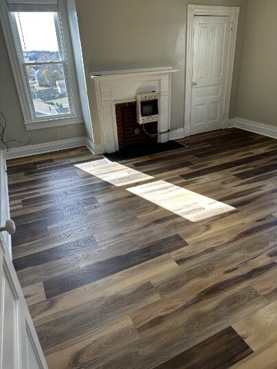 interior space with heating unit and dark hardwood / wood-style floors