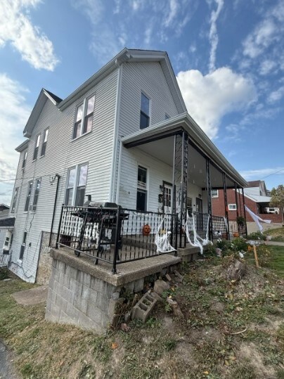 back of property with a porch