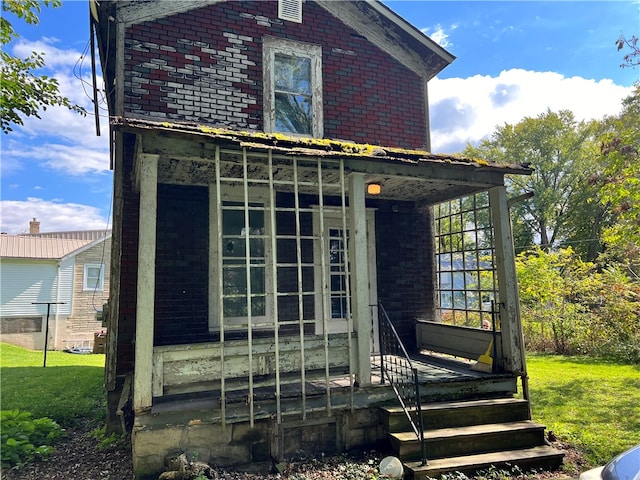 rear view of house with a yard