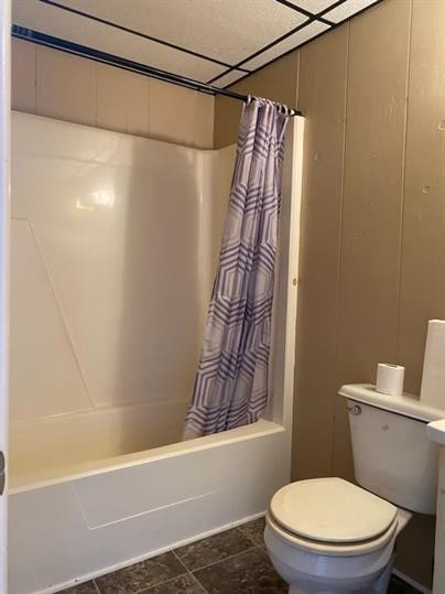 bathroom with shower / bath combo and toilet