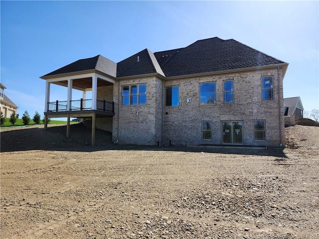 rear view of house featuring brick siding