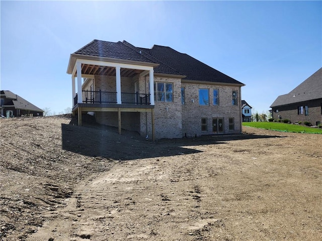 back of house featuring brick siding