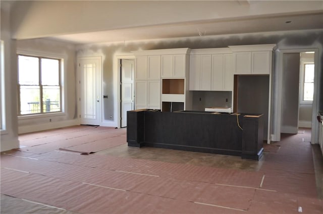 207 Falcon Ln, Cranberry Twp, PA 16066 - kitchen with white cabinetry, healthy amount of natural light, and a kitchen island