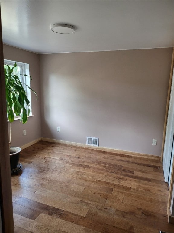 unfurnished room featuring wood-type flooring