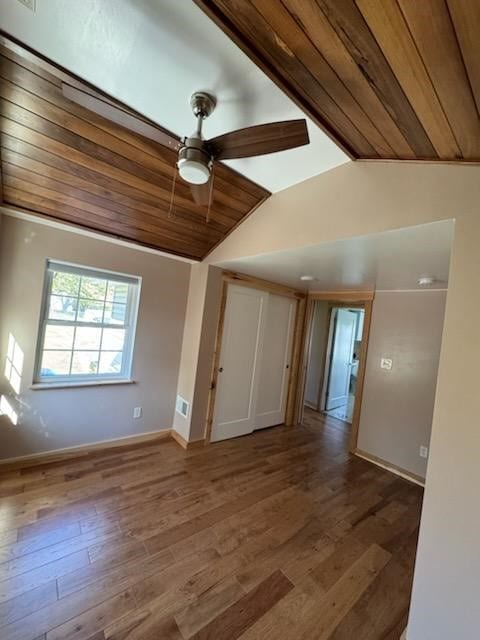 empty room featuring hardwood / wood-style flooring, ceiling fan, lofted ceiling, and wood ceiling