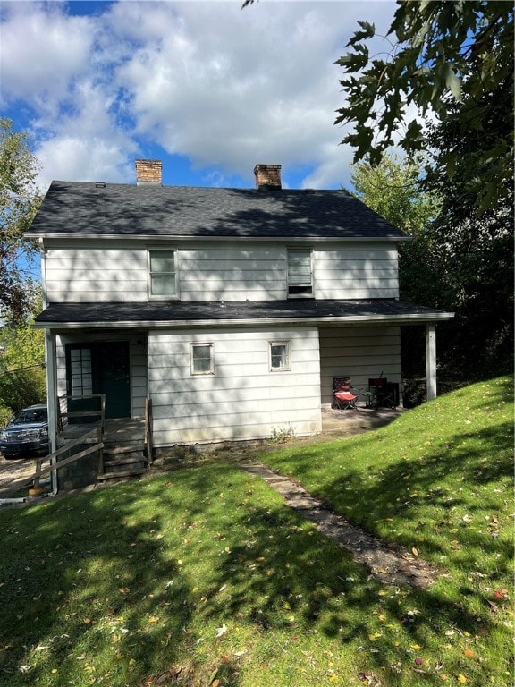 rear view of house with a lawn