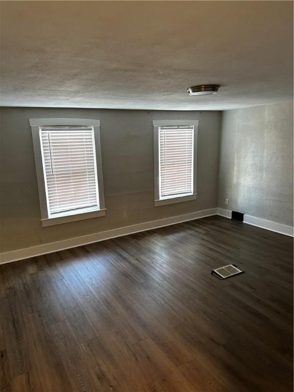 spare room featuring dark hardwood / wood-style floors