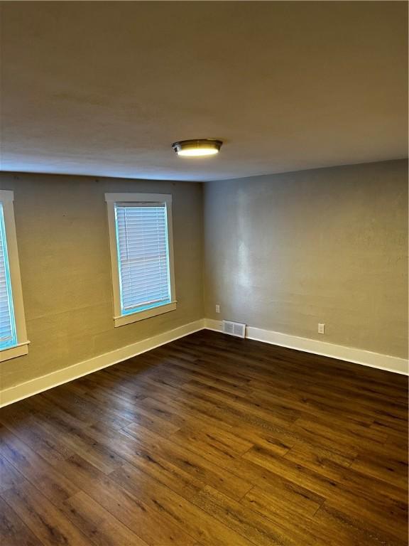 spare room with dark hardwood / wood-style flooring