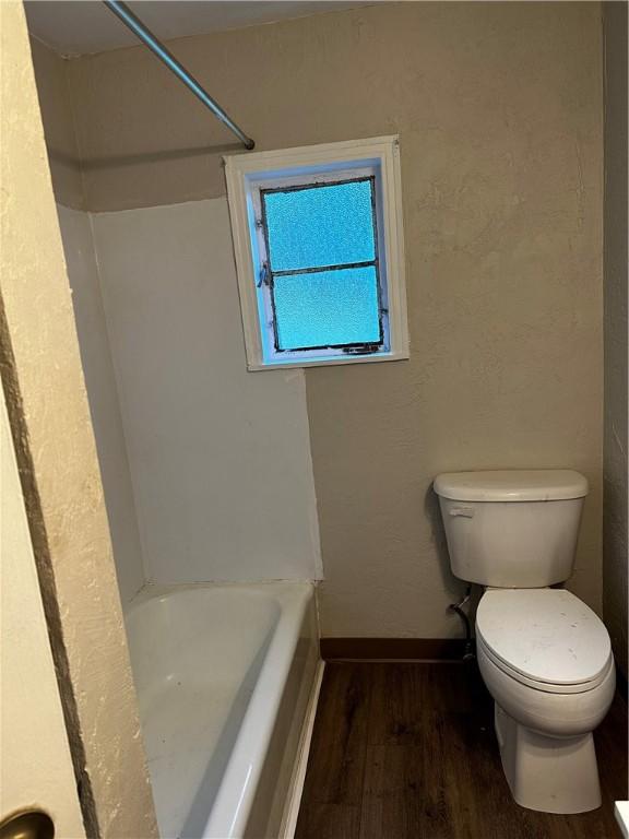 bathroom with hardwood / wood-style floors and toilet