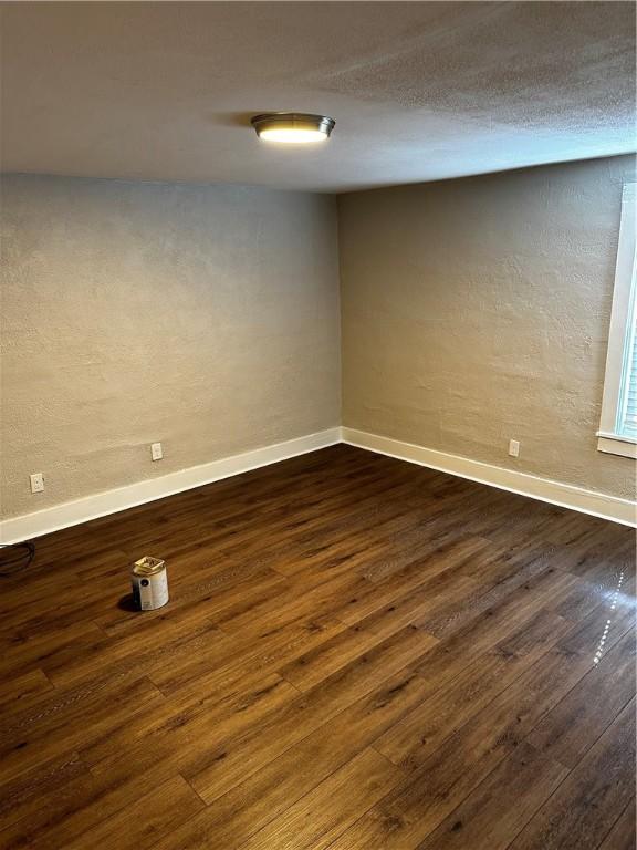 basement featuring dark hardwood / wood-style flooring