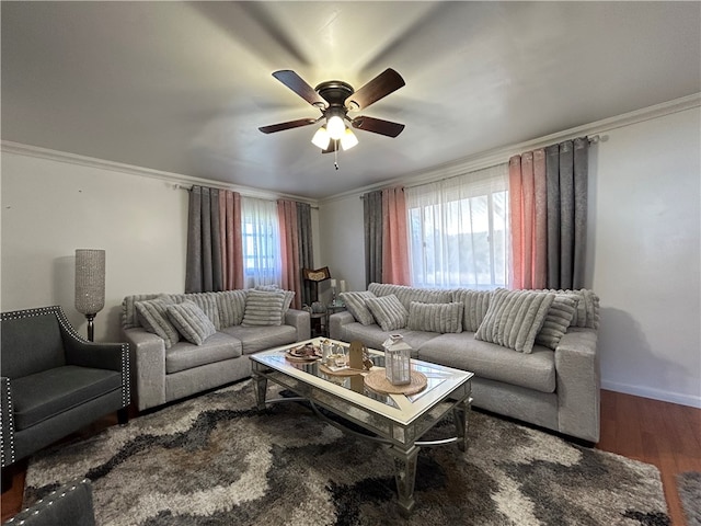 living room featuring ceiling fan, ornamental molding, dark hardwood / wood-style flooring, and a healthy amount of sunlight