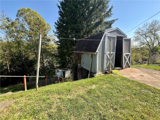 view of outbuilding with a lawn