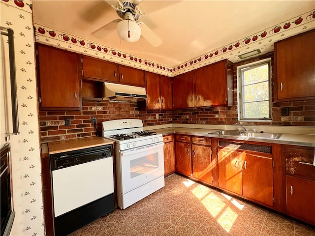 kitchen featuring white appliances, sink, ceiling fan, and tasteful backsplash