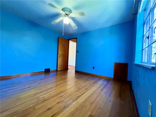 empty room with light hardwood / wood-style floors and ceiling fan