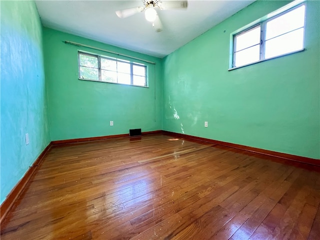 empty room featuring hardwood / wood-style floors and ceiling fan