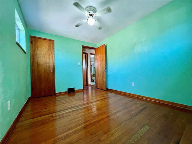 unfurnished bedroom featuring ceiling fan and hardwood / wood-style flooring