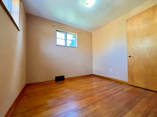 empty room featuring wood-type flooring