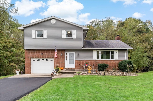 view of front of house with a front yard and a garage