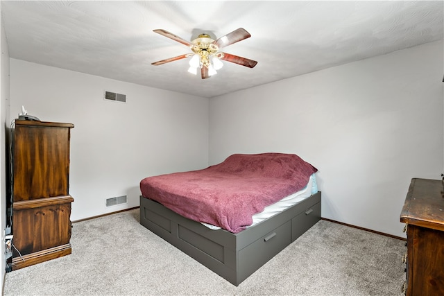 bedroom with ceiling fan and light colored carpet