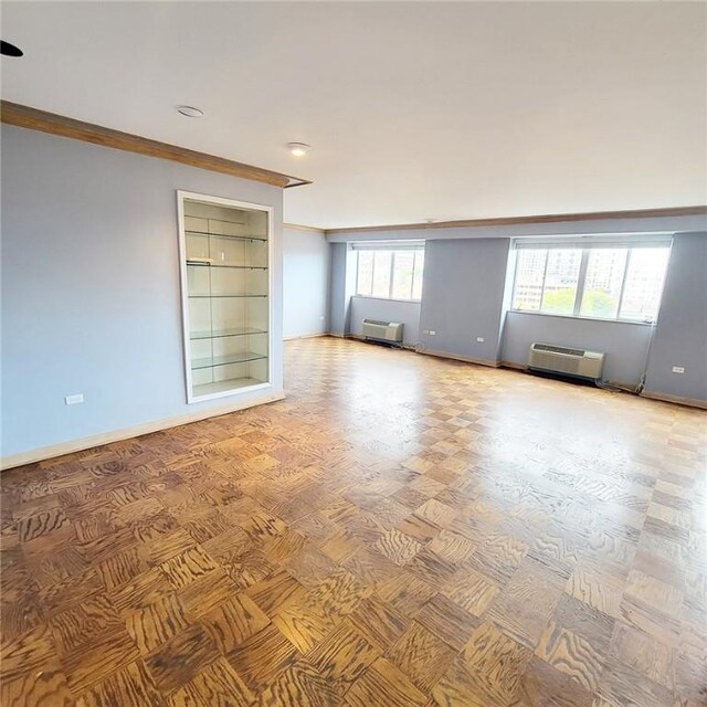 128 N Craig St Unit 703, Oakland, PA 15213 - empty room with crown molding, an AC wall unit, and baseboards
