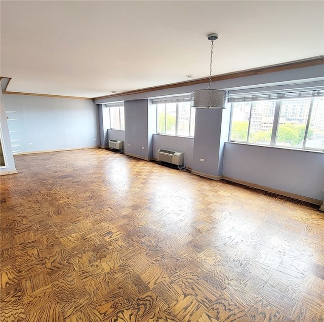 spare room featuring ornamental molding and a wall unit AC