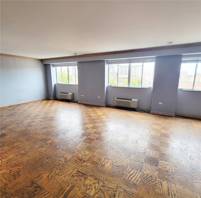 empty room featuring crown molding and a wall unit AC