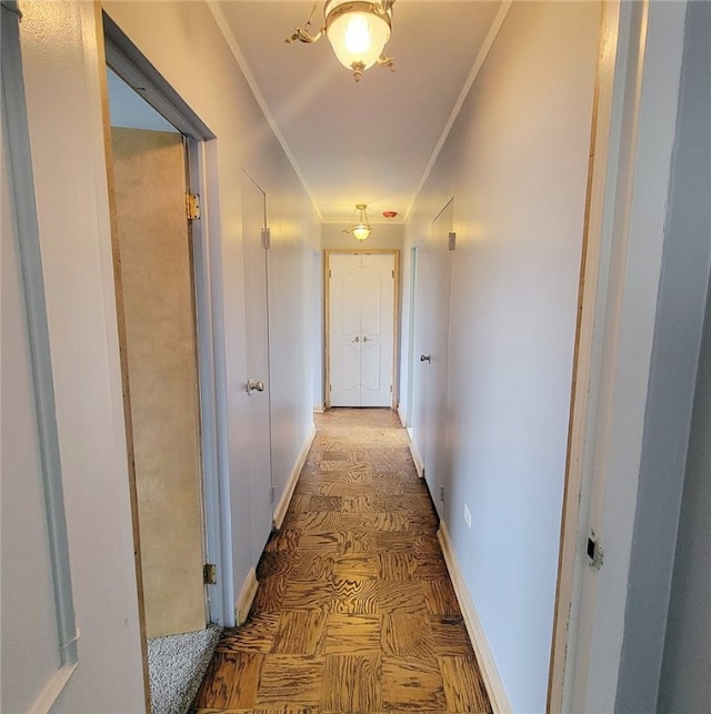 hall featuring parquet flooring and crown molding