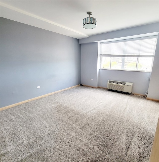 spare room featuring carpet floors and a wall mounted air conditioner