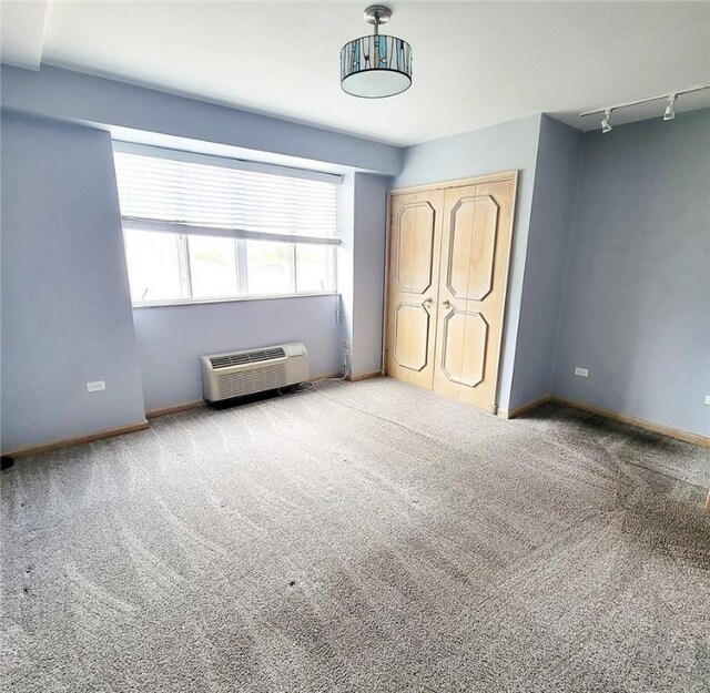 128 N Craig St Unit 703, Oakland, PA 15213 - unfurnished bedroom featuring track lighting, a closet, a wall mounted AC, and carpet floors