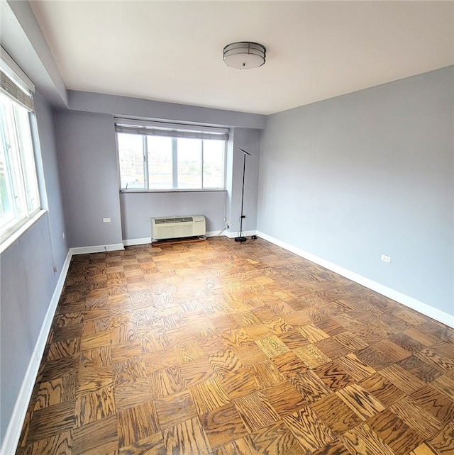 unfurnished room featuring a wall unit AC