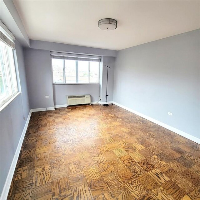 128 N Craig St Unit 703, Oakland, PA 15213 - unfurnished room with an AC wall unit and baseboards