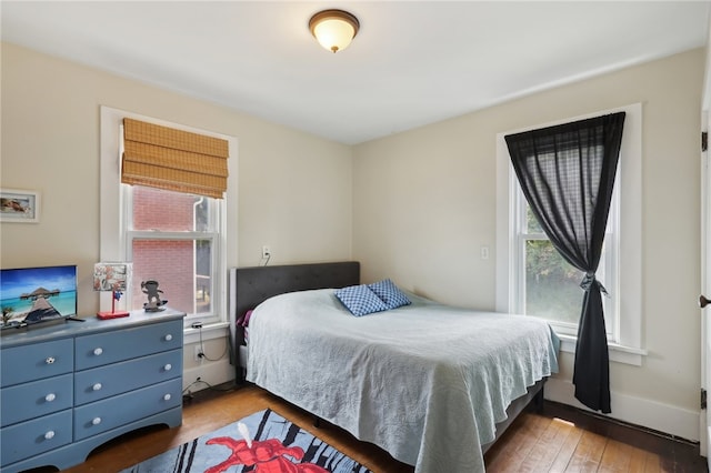 bedroom featuring light wood-type flooring and multiple windows